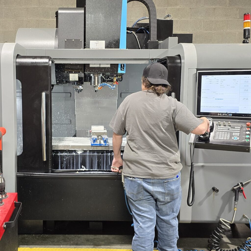 Worker creating a prototype with CNC machine